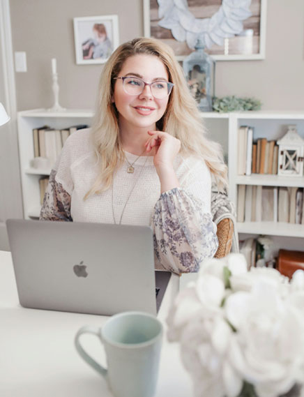 portrait photo of happy lady at desk